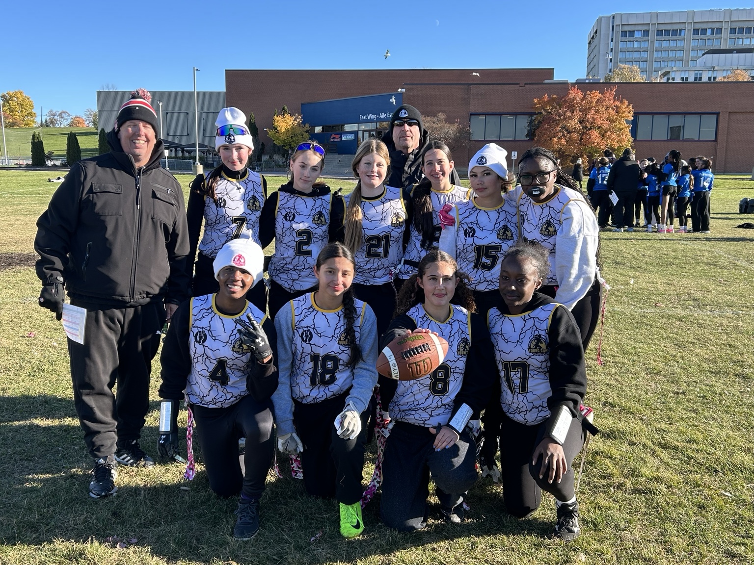Girls flag football team and coaches